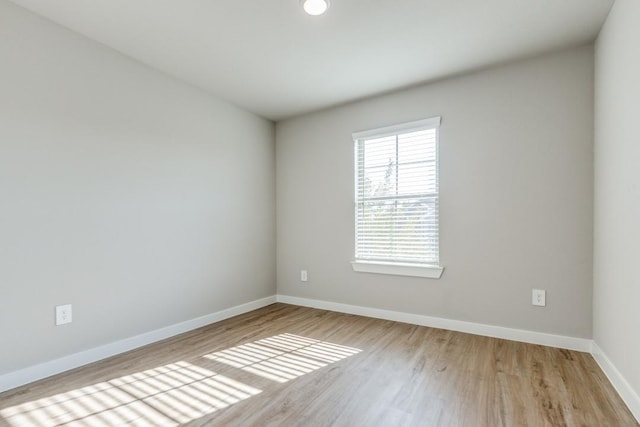 unfurnished room with light wood-type flooring