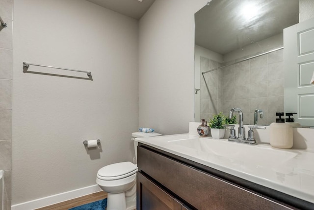 bathroom with vanity, wood-type flooring, and toilet