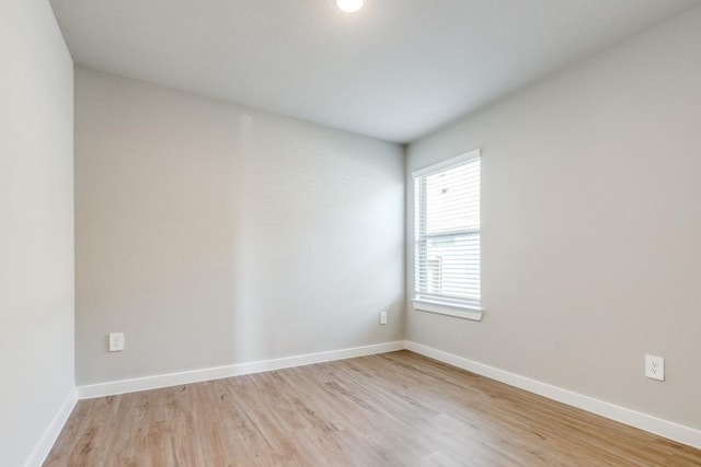 spare room with light hardwood / wood-style flooring