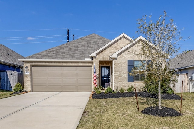 view of front of property with a garage and a front lawn