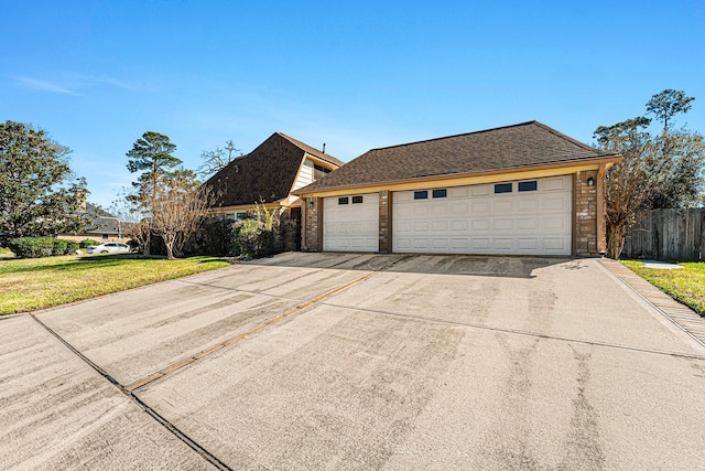 exterior space featuring a garage and a yard