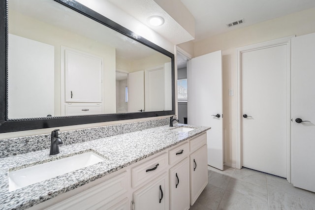 bathroom with tile patterned floors and vanity