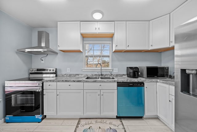 kitchen with white cabinets, sink, wall chimney exhaust hood, light stone counters, and stainless steel appliances