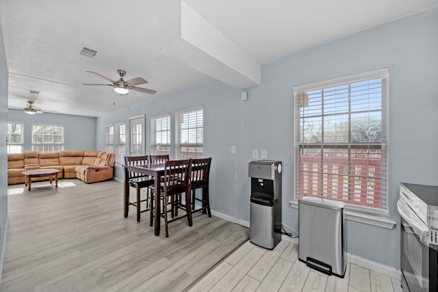 dining area featuring light wood-type flooring and ceiling fan