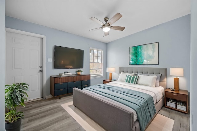 bedroom with ceiling fan and light hardwood / wood-style flooring