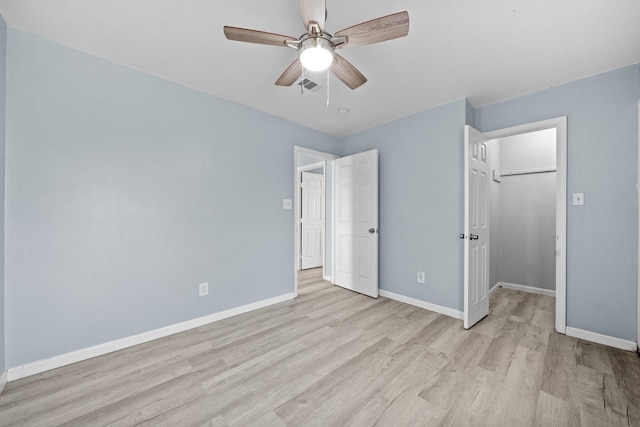 unfurnished bedroom featuring ceiling fan and light wood-type flooring