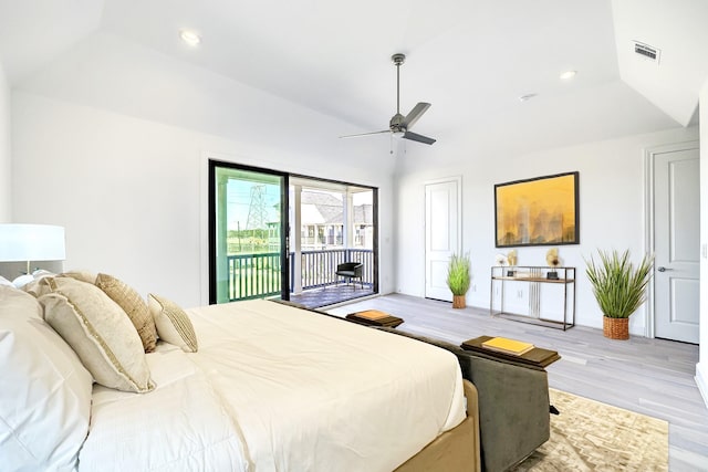 bedroom with a tray ceiling, access to exterior, ceiling fan, and light hardwood / wood-style floors