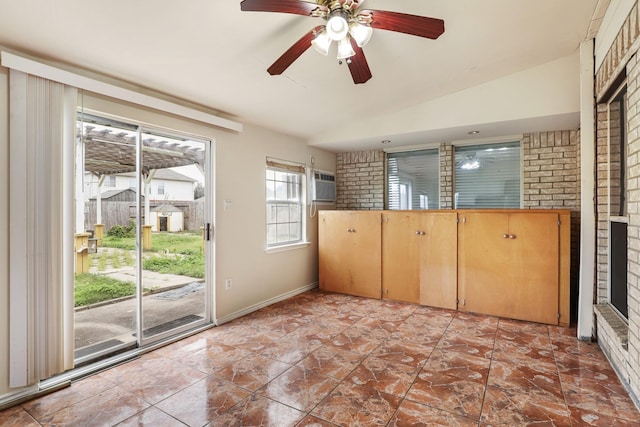 interior space featuring ceiling fan, lofted ceiling, and an AC wall unit