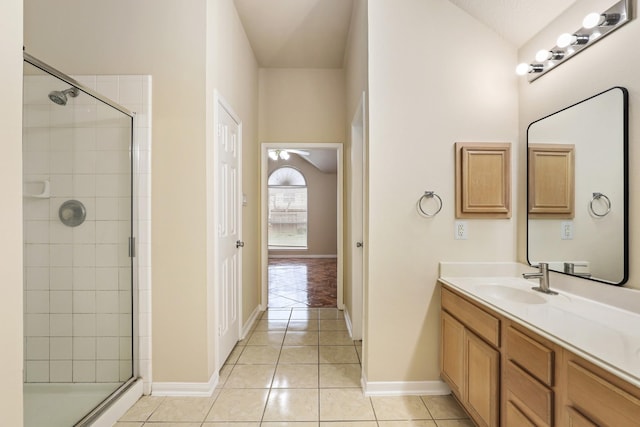 bathroom with ceiling fan, vanity, tile patterned flooring, and a shower with shower door