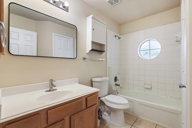 full bathroom featuring toilet, tiled shower / bath combo, tile patterned floors, and vanity