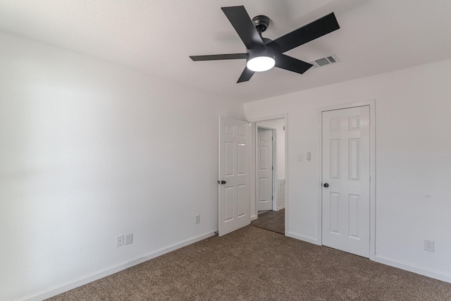 unfurnished bedroom with carpet floors and ceiling fan