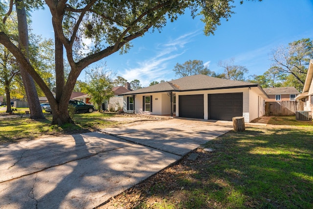 ranch-style house with central AC, a front yard, and a garage