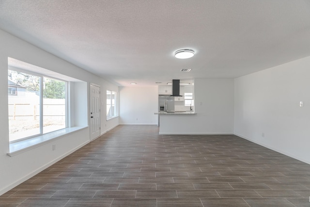 unfurnished living room featuring a textured ceiling