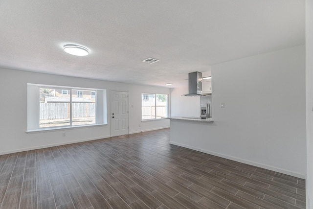 unfurnished living room featuring dark hardwood / wood-style floors