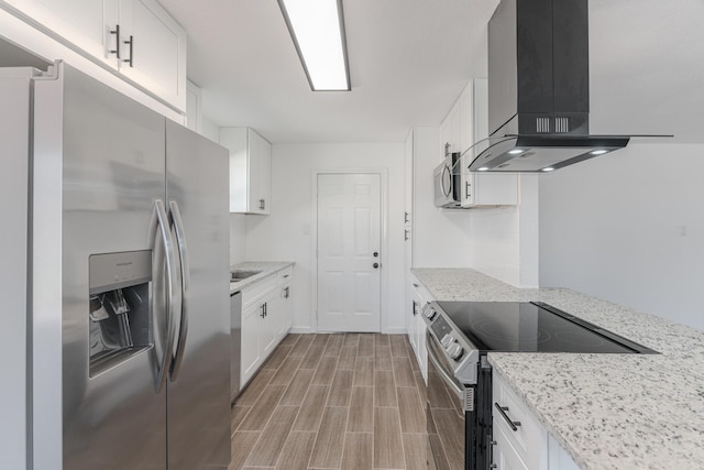 kitchen with white cabinets, island exhaust hood, and stainless steel appliances