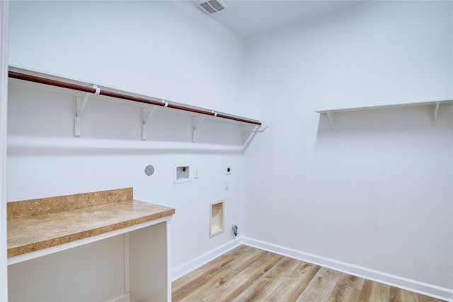 laundry room with electric dryer hookup, gas dryer hookup, washer hookup, and light wood-type flooring