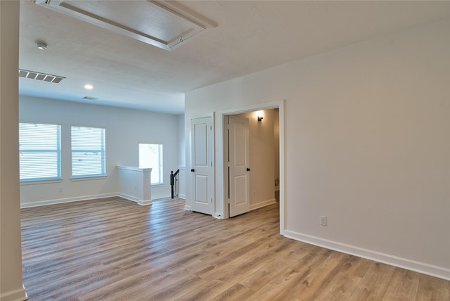 spare room featuring light hardwood / wood-style floors