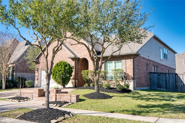 view of front facade featuring a front yard and a garage