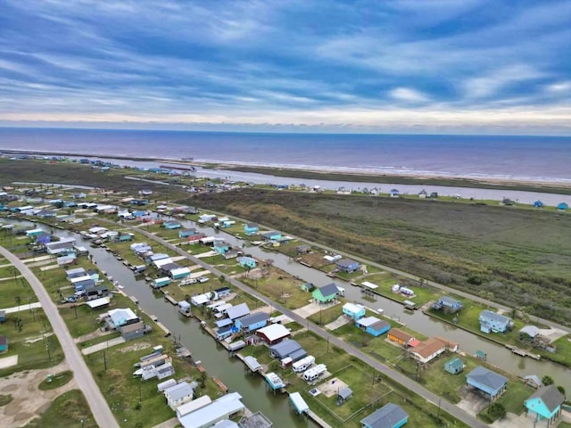 bird's eye view featuring a water view and a beach view