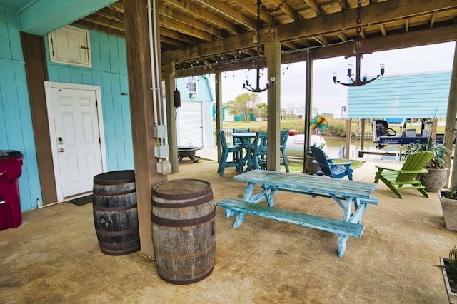 view of patio / terrace featuring a water view and a boat dock