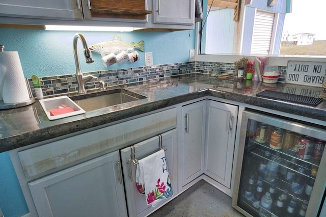 kitchen with backsplash, beverage cooler, gray cabinetry, and sink