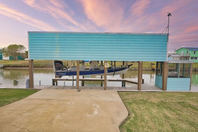 dock area with a yard and a water view