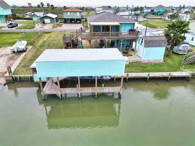 exterior space with a deck with water view and a storage unit