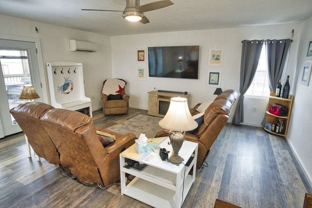 living room with hardwood / wood-style flooring, ceiling fan, a textured ceiling, and a wall mounted AC