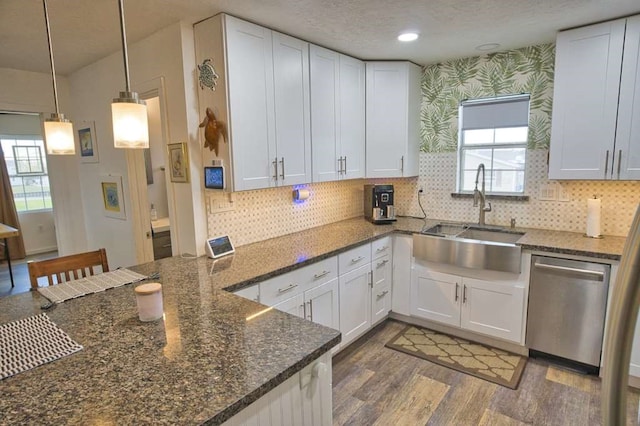 kitchen with dishwasher, white cabinets, and sink