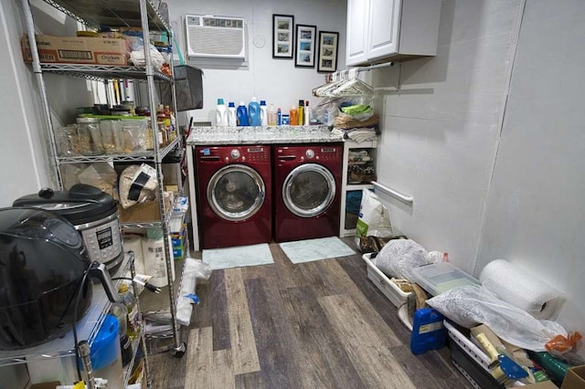 washroom with cabinets, hardwood / wood-style floors, and washer and dryer