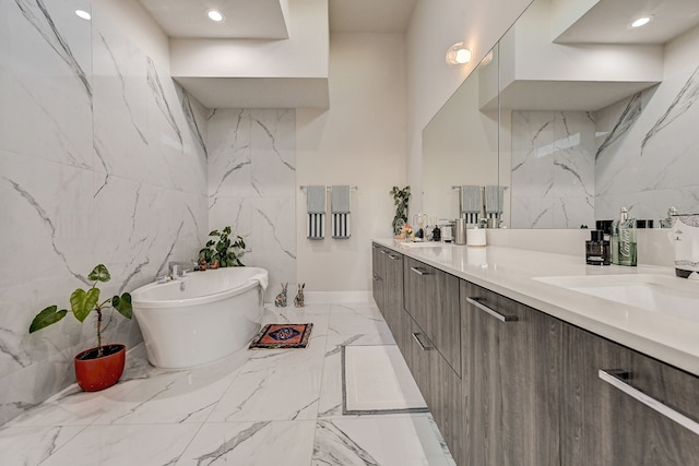 bathroom featuring a washtub and vanity