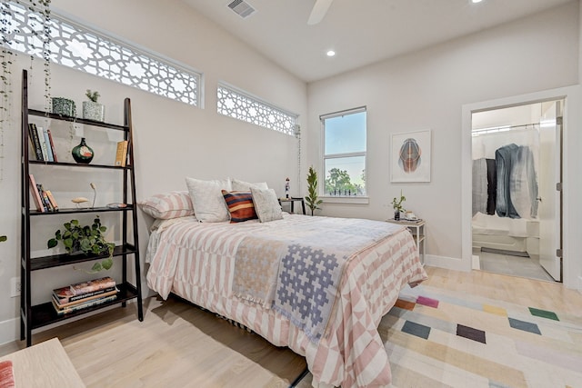 bedroom featuring ensuite bathroom, ceiling fan, and light hardwood / wood-style floors