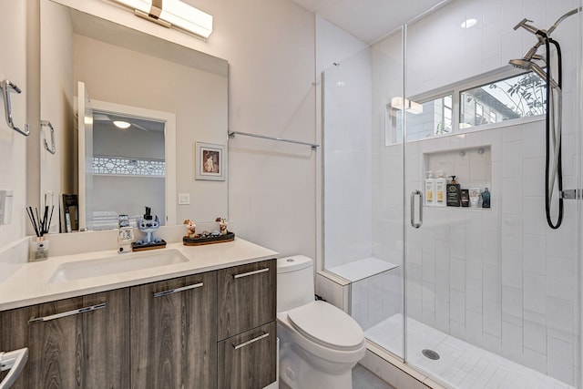 bathroom featuring vanity, an enclosed shower, and toilet