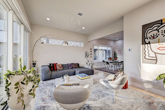 living room with a healthy amount of sunlight and a chandelier