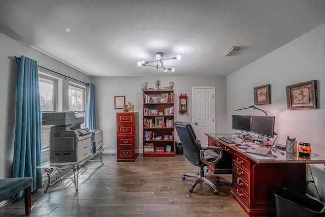 office space featuring a notable chandelier and hardwood / wood-style flooring