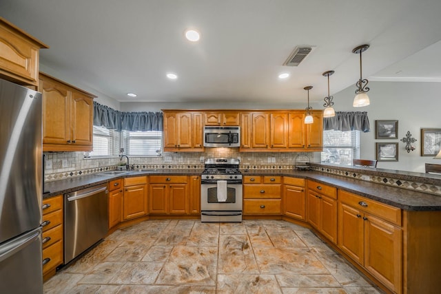 kitchen with stainless steel appliances, tasteful backsplash, sink, hanging light fixtures, and crown molding