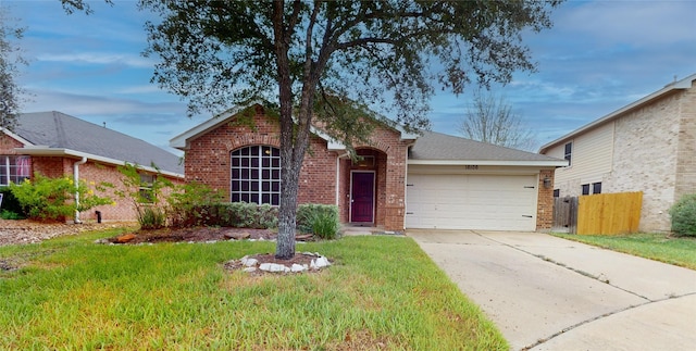 view of front of property featuring a front lawn and a garage