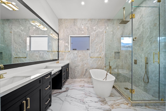 bathroom with tile walls, vanity, and independent shower and bath