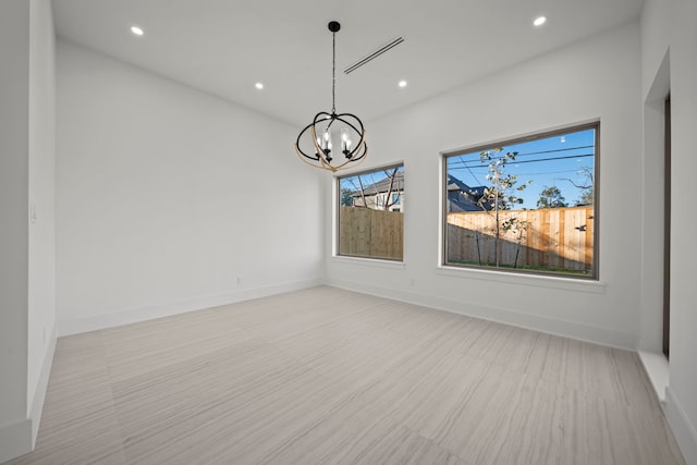 unfurnished dining area with an inviting chandelier