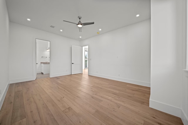 unfurnished bedroom with ceiling fan, light wood-type flooring, and connected bathroom