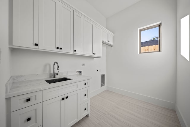 washroom featuring cabinets, hookup for a washing machine, hookup for an electric dryer, sink, and gas dryer hookup