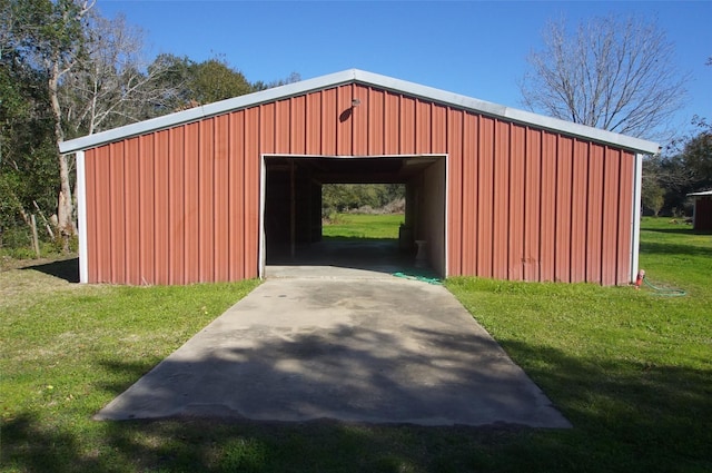 view of outbuilding with a yard