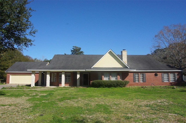 back of property with a garage and a yard