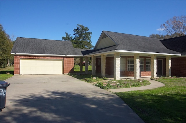 view of front of property with a porch, a garage, and a front lawn