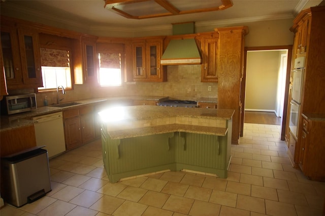 kitchen with sink, a center island, custom range hood, and white appliances