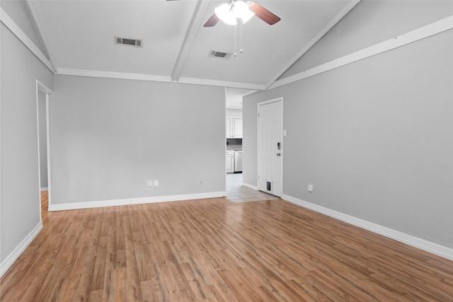 unfurnished room featuring vaulted ceiling with beams, light hardwood / wood-style flooring, and ceiling fan