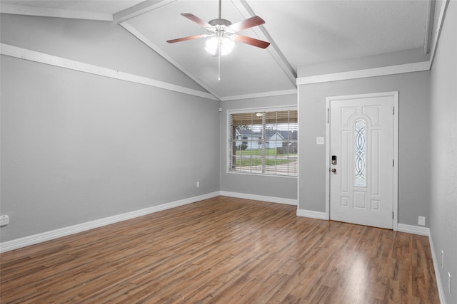 entrance foyer featuring hardwood / wood-style flooring, lofted ceiling with beams, and ceiling fan