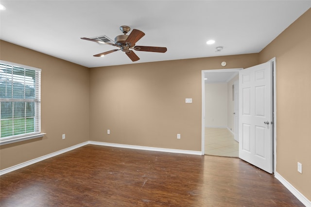 spare room with ceiling fan and dark hardwood / wood-style floors