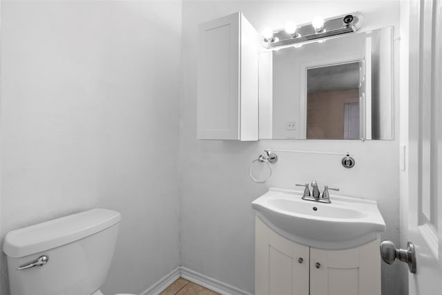 bathroom featuring tile patterned floors, vanity, and toilet