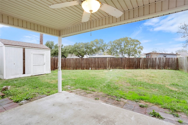 view of yard with ceiling fan and a patio area